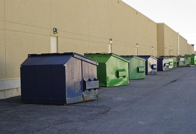 a red construction dumpster placed in front of a building under construction in Arlington Heights IL